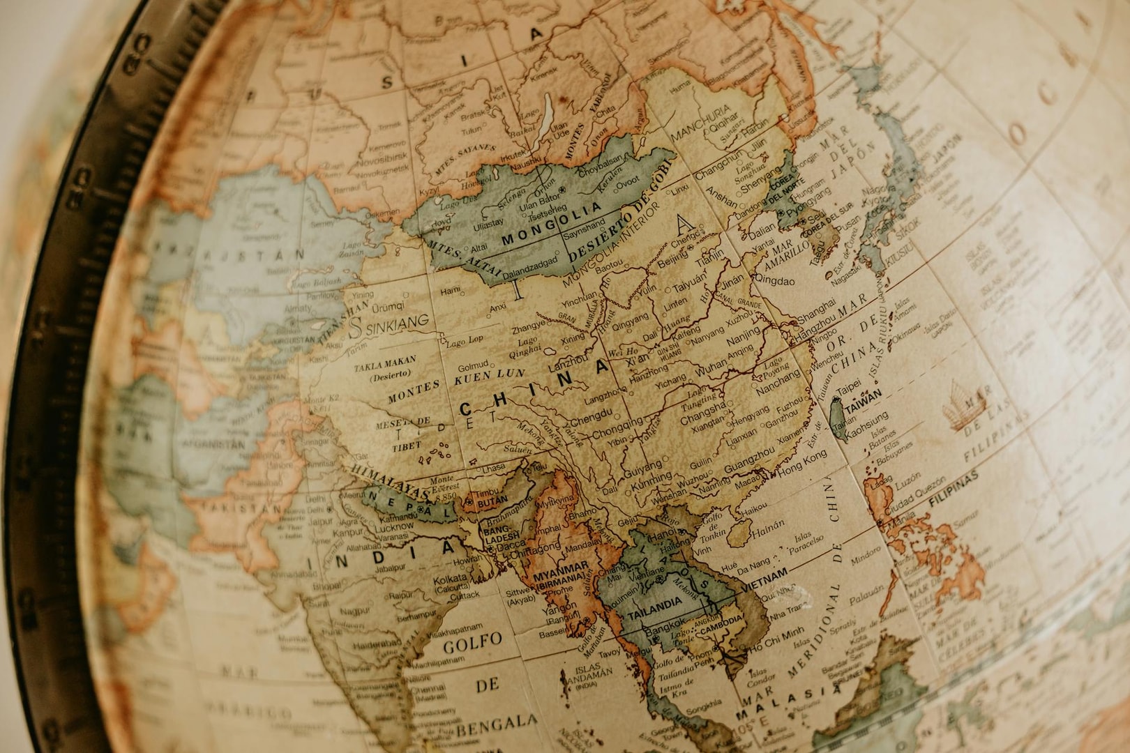Detailed vintage globe map highlighting Asia, featuring countries like China and India.