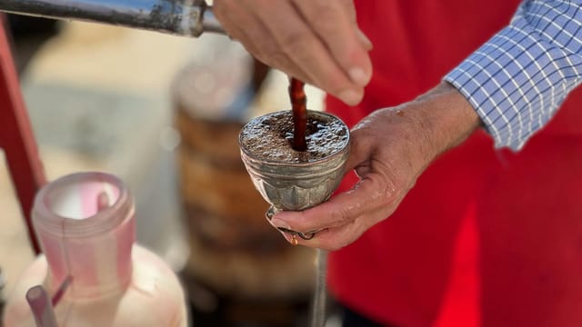 Man preparing traditional coffee in Batman, Türkiye, showcasing artisanal skills.