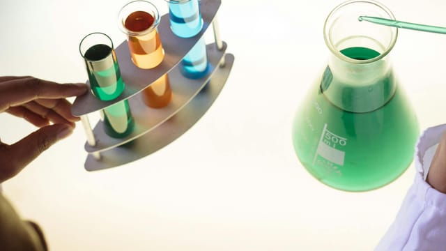 A vibrant science experiment involving colorful liquids in test tubes and a flask.
