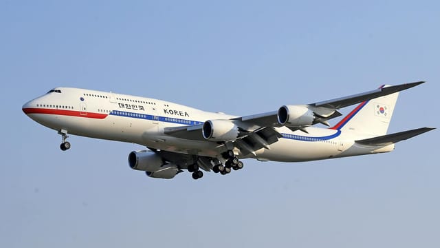 A South Korean aircraft flying against a clear blue sky.