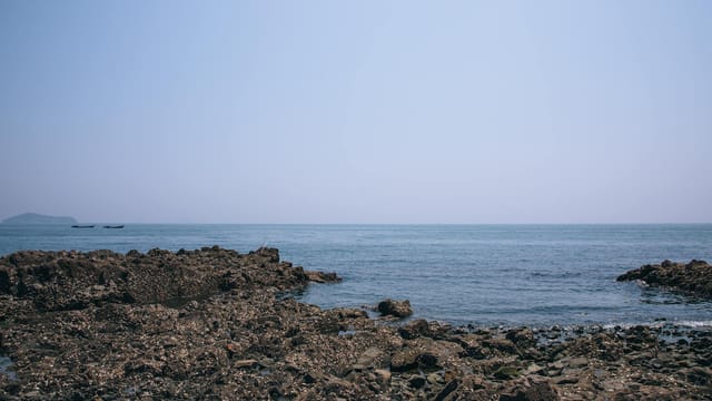 Explore the serene rocky coastline of Dalian, Liaoning Province, China.