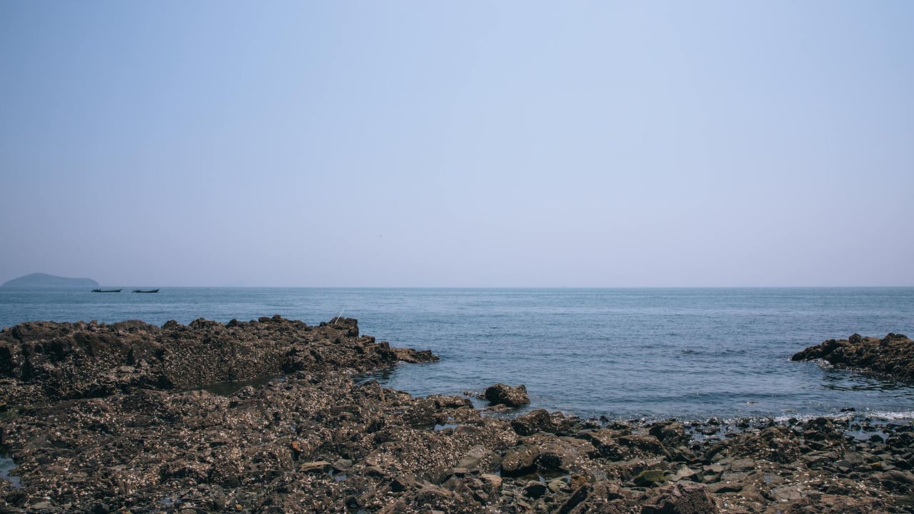 Explore the serene rocky coastline of Dalian, Liaoning Province, China.