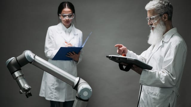 Scientists in a lab working with a robot, focusing on technological innovation and development.