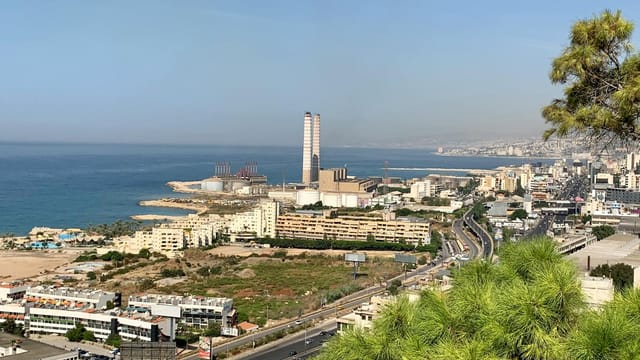 A beautiful aerial view showcasing a coastal city's urban skyline by the sea.