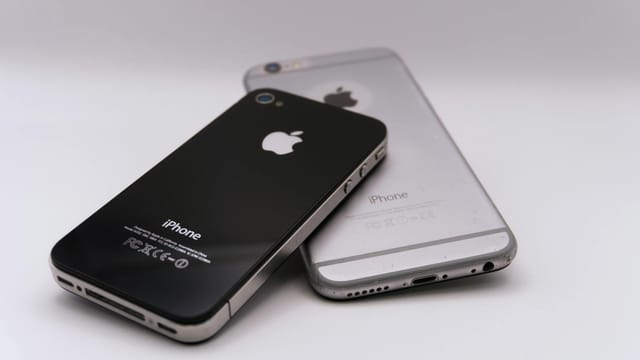 Two smartphones displayed on a white surface, showcasing modern technology.