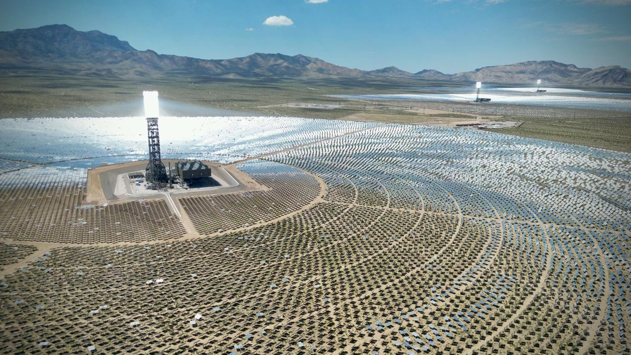 Stunning aerial view of the Ivanpah Solar Electric Generating System with mountainous backdrop.