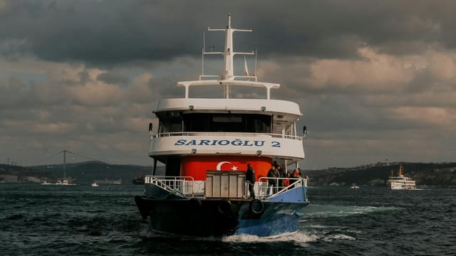 Ferry 'SARIOĞLU 2' navigating the Bosphorus with scenic background.