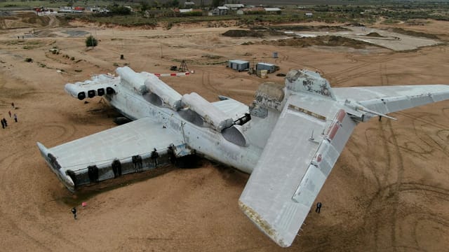 Aerial view of a Soviet-era ekranoplan stranded in Dagestan's arid landscape.