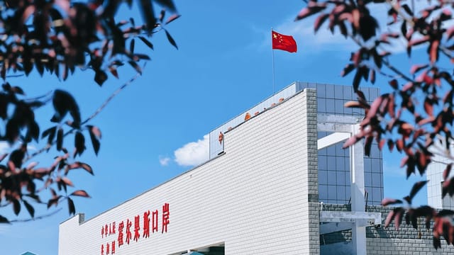 A view of Korghos Port featuring the Chinese flag on a sunny day.