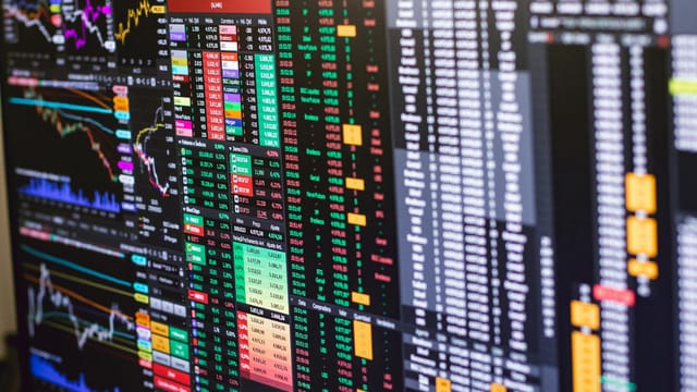 Detailed financial trading screen with colorful charts and data representing market fluctuations.