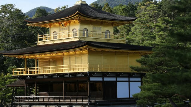 Explore the serene beauty of Kinkaku-ji, the iconic Golden Pavilion in Kyoto surrounded by lush greenery.