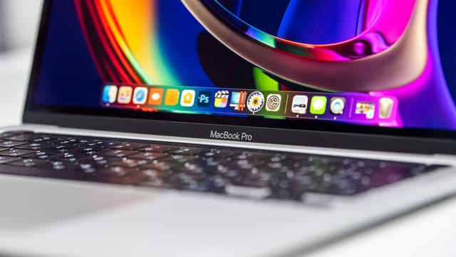 A vibrant close-up of a MacBook Pro showcasing its colorful screen and keyboard.