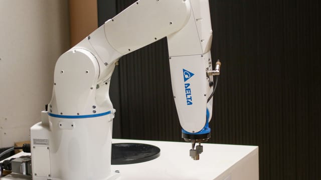 Illustrative image: Close-up of a Delta brand robotic arm in an industrial setting, showcasing automation technology.