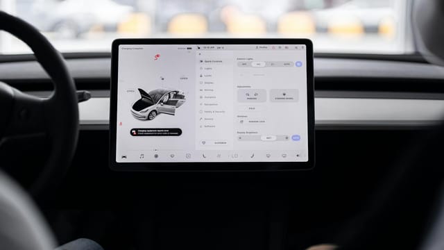 View of a modern car's dashboard featuring a digital display panel with control options.