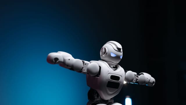 Close-up of a futuristic robot toy with glowing eyes against a blue background, symbolizing innovation.