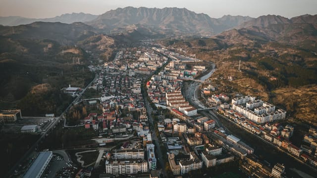 Explore the stunning aerial view of Hanzhong, nestled between mountains and valleys in Shaanxi, China.