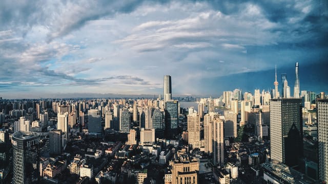 Illustrative image: A breathtaking panoramic view of Shanghai's modern skyline under a dramatic sky.
