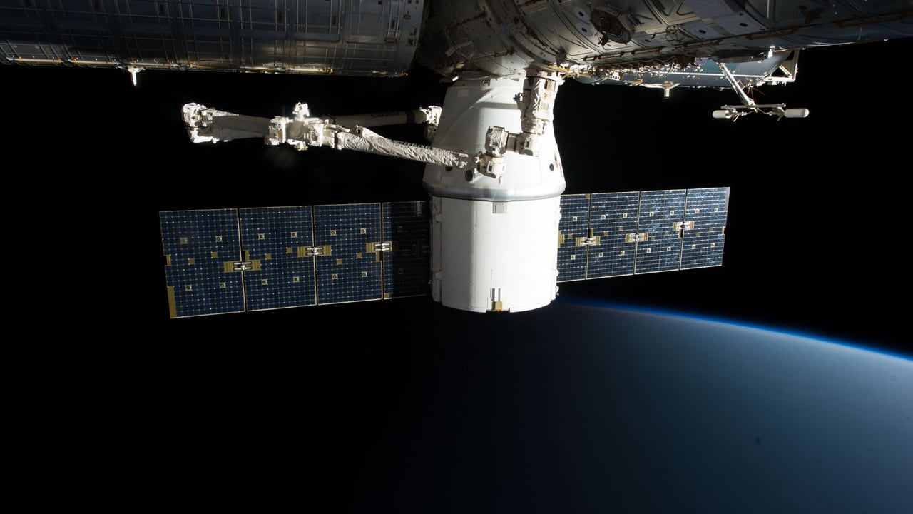 A SpaceX satellite hovering over Earth's horizon in outer space, showcasing advanced space technology.