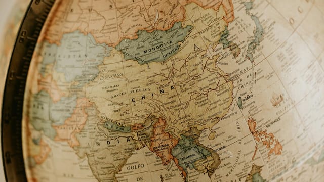 Detailed vintage globe map highlighting Asia, featuring countries like China and India.
