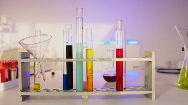 Illustrative image: Vibrant test tubes filled with liquids in a modern lab setting, showcasing scientific exploration.