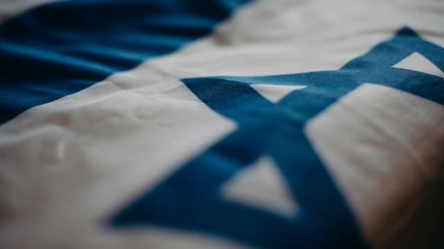 Detail of the Israeli national flag highlighting the Star of David, emphasizing its cultural significance.