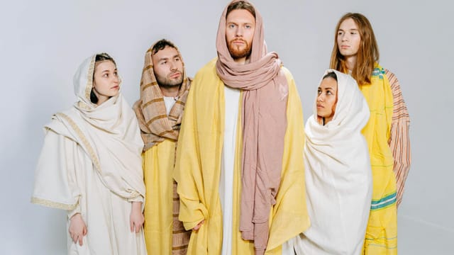 Adults in biblical costumes posing for a conceptual group studio shoot.