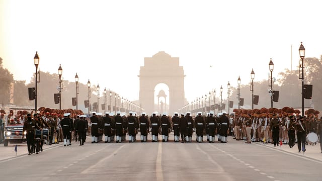 A grand military parade in front of the iconic India Gate in New Delhi, India.