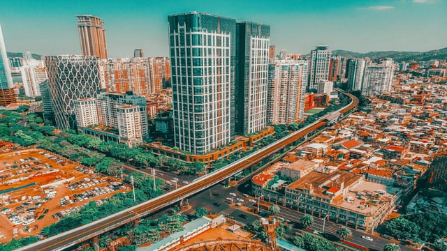 Stunning aerial view of modern skyscrapers and vibrant urban landscape in Xiamen, China.