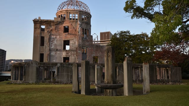 Historic Hiroshima Peace Memorial Dome in Japan at sunset, showcasing urban heritage.