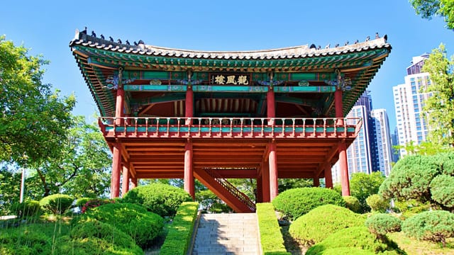 Beautiful Korean pavilion in Daegu with modern city backdrop, captured on a sunny day.