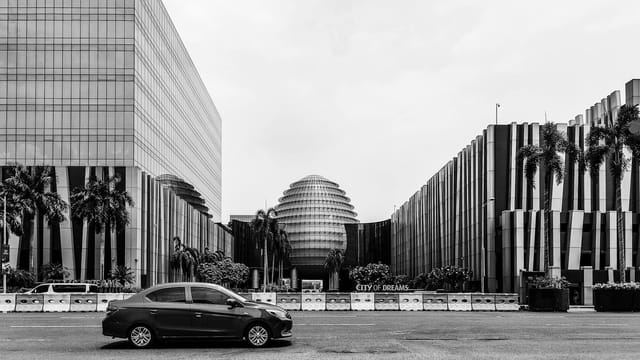 Black and white photo of City of Dreams in Parañaque, featuring sleek modern architecture and a street view.