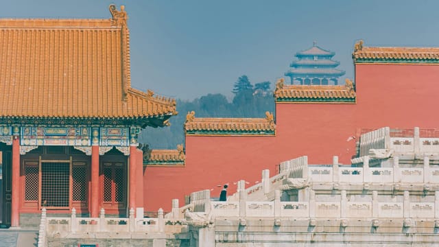 A view of the Forbidden City's ornate architecture and red walls in Beijing, China.