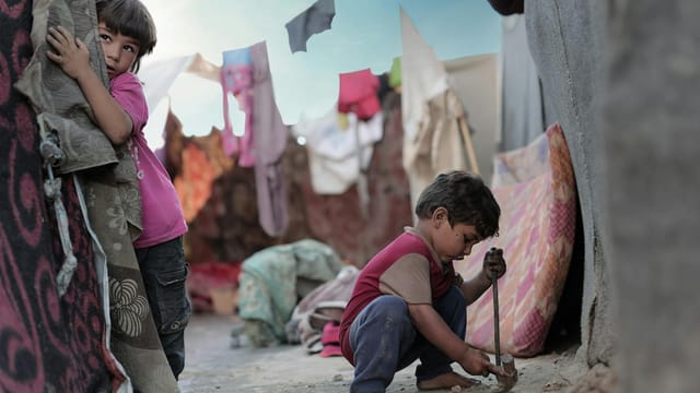 Children playing in a vibrant Gaza alleyway, capturing the resilient spirit of youth.