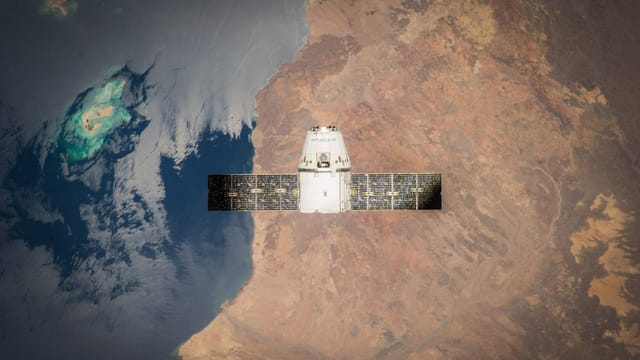 Satellite in orbit with detailed view of Earth and ocean below.