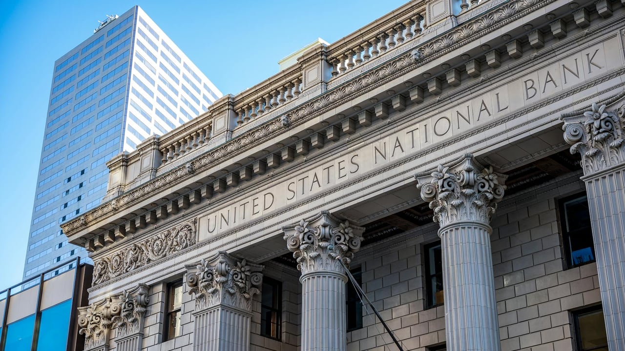 Close view of the United States National Bank building with classic columns and architecture.
