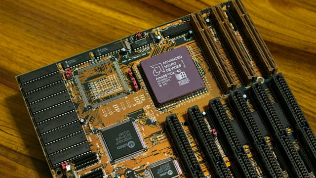 Close-up of a vintage AMD motherboard featuring the AM486 DX processor, showcasing retro computing technology.