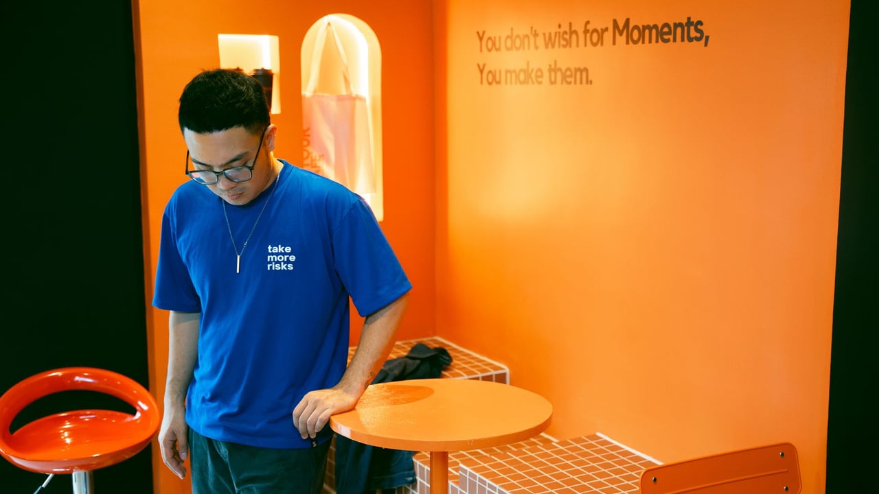 Stylish modern cafe with motivational quotes featuring a young adult in casual attire.