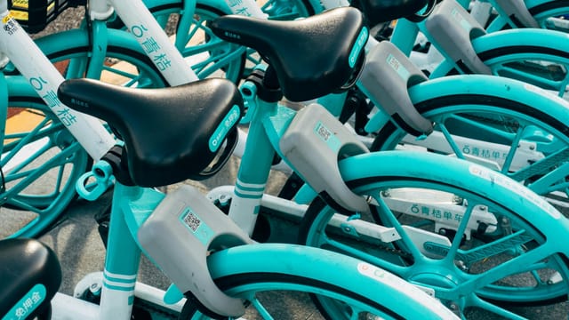 Colorful rental bicycles parked outdoors in Beijing, China.