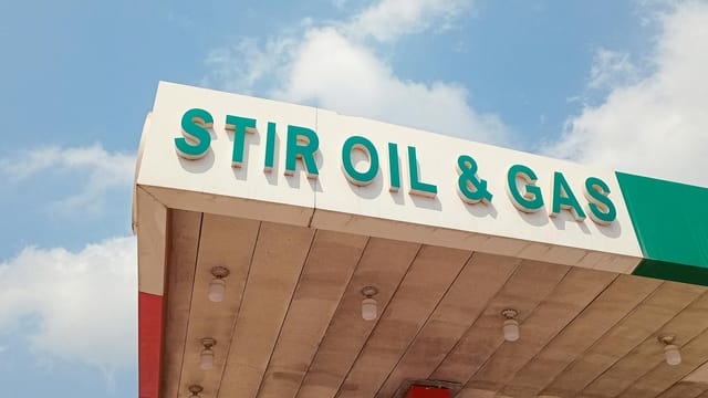 Close-up of Stir Oil & Gas sign at a filling station in Ikorodu, Nigeria under bright sky.