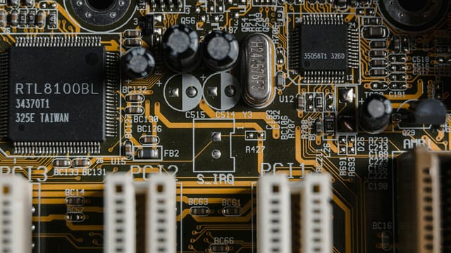 Detailed view of a motherboard with visible microchips and circuits.