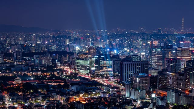 A breathtaking aerial view of a vibrant city illuminated at night.