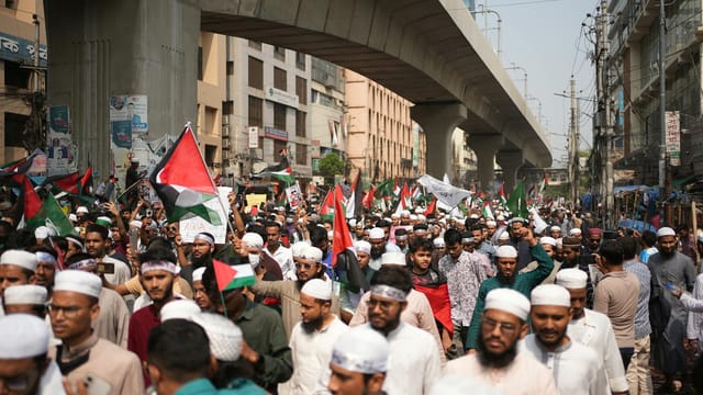 Crowd of Pro-Palestinian demonstrators with flags in Dhaka, Bangladesh.
