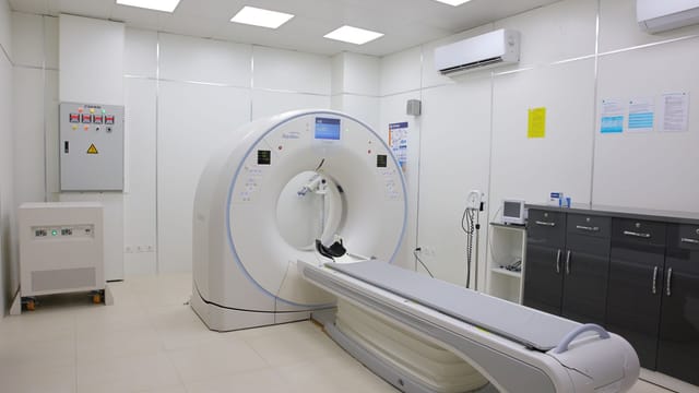Bright and sterile hospital imaging room featuring a state-of-the-art CT scanner.