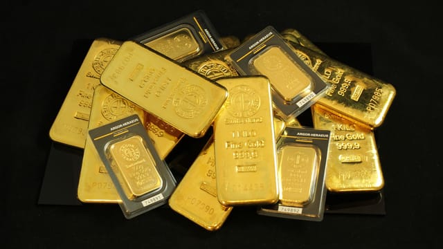 A collection of precious gold bars stacked elegantly, symbolizing wealth and prosperity.