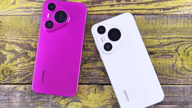 A vibrant purple and sleek white smartphone on a rustic wooden surface, showcasing modern technology and design.