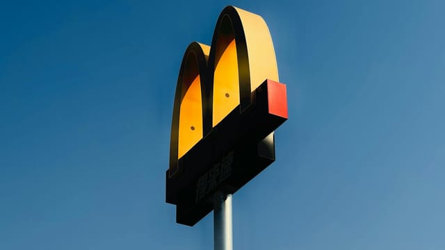 Vibrant McDonald's sign on a clear day in Tianjin, China.