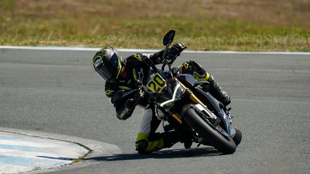 Motorcyclist in racing gear taking a sharp corner on a track in Central Luzon.