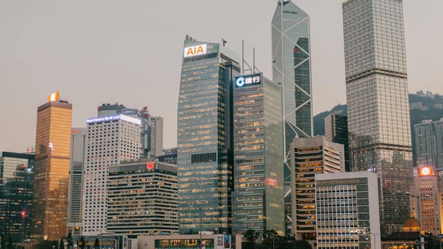 Stunning view of Hong Kong's iconic skyscrapers during twilight, capturing the city's urban glow.