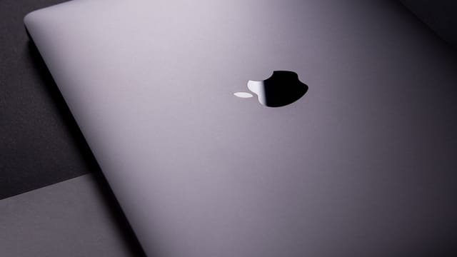 Close-up of a sleek, modern laptop featuring a minimalist design on a dark surface.