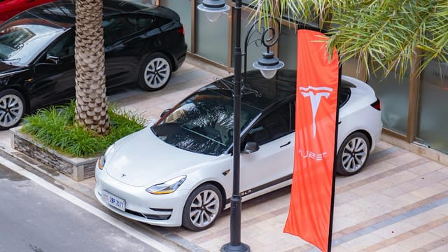 High-angle view of electric cars parked in an urban area, showcasing sleek design and eco-friendly transportation.